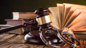 Gavel on a desk with other legal paraphernalia.