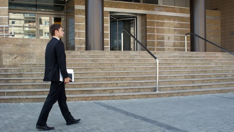 Lawyer walking in front of courthouse steps.