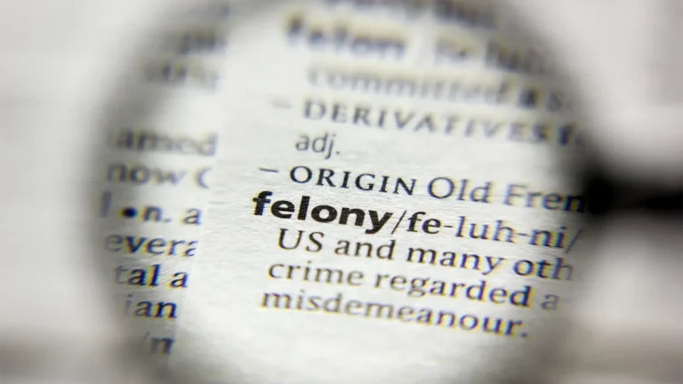 The word "felony" under a microscope in a dictionary - get a felony defense attorney when it matters
